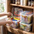 Person organising a cupboard with clear pantry bins