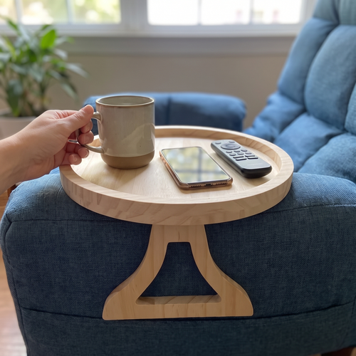 Person resting a drink and remote on the bamboo sofa armrest tray