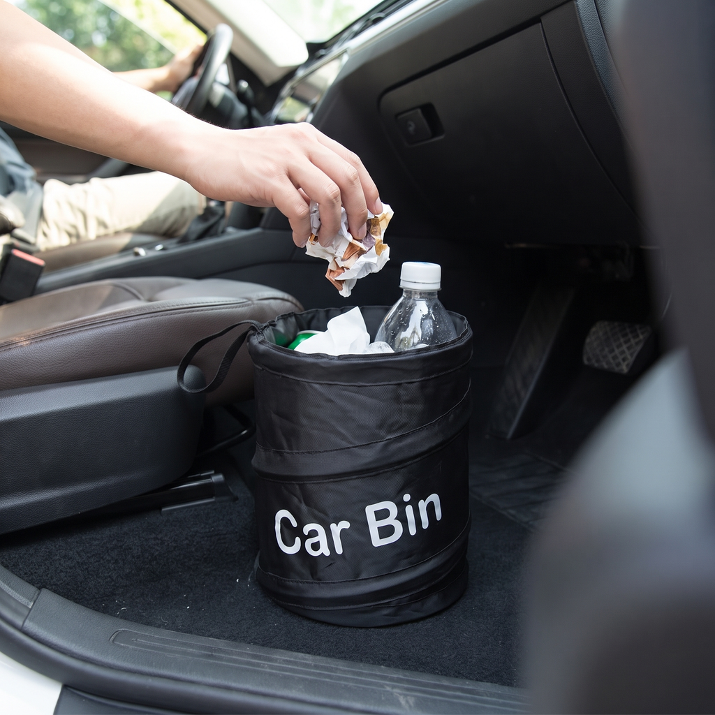 Person putting rubbish in the leakproof car trash can, tidy interior