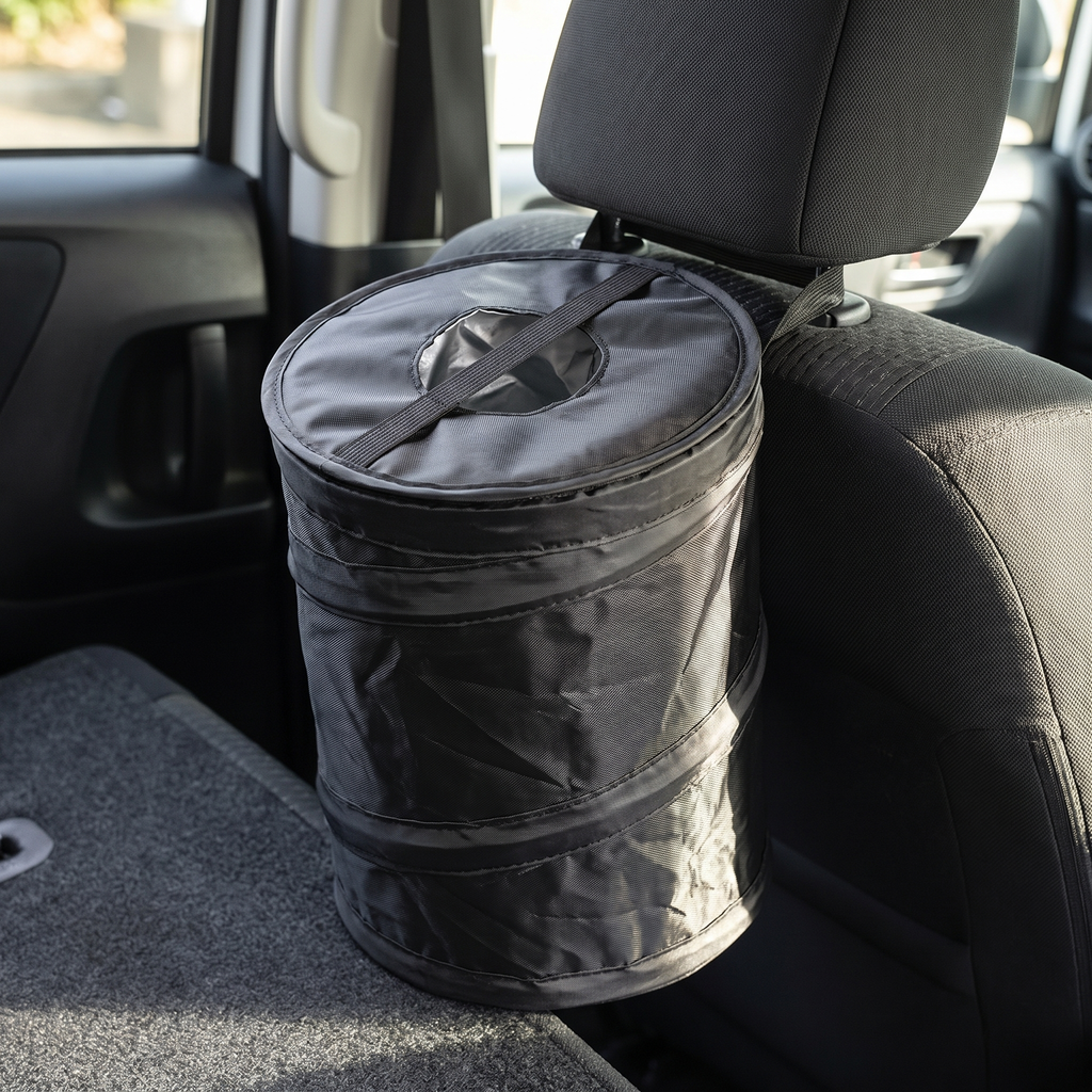 Leakproof car trash can with lid mounted behind a seat