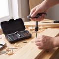 Person driving a screw with the ratcheting multi-bit screwdriver