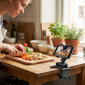 Person following a recipe hands-free on a phone in a foldable stand