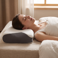 Person sleeping with neck supported on a memory foam cervical pillow