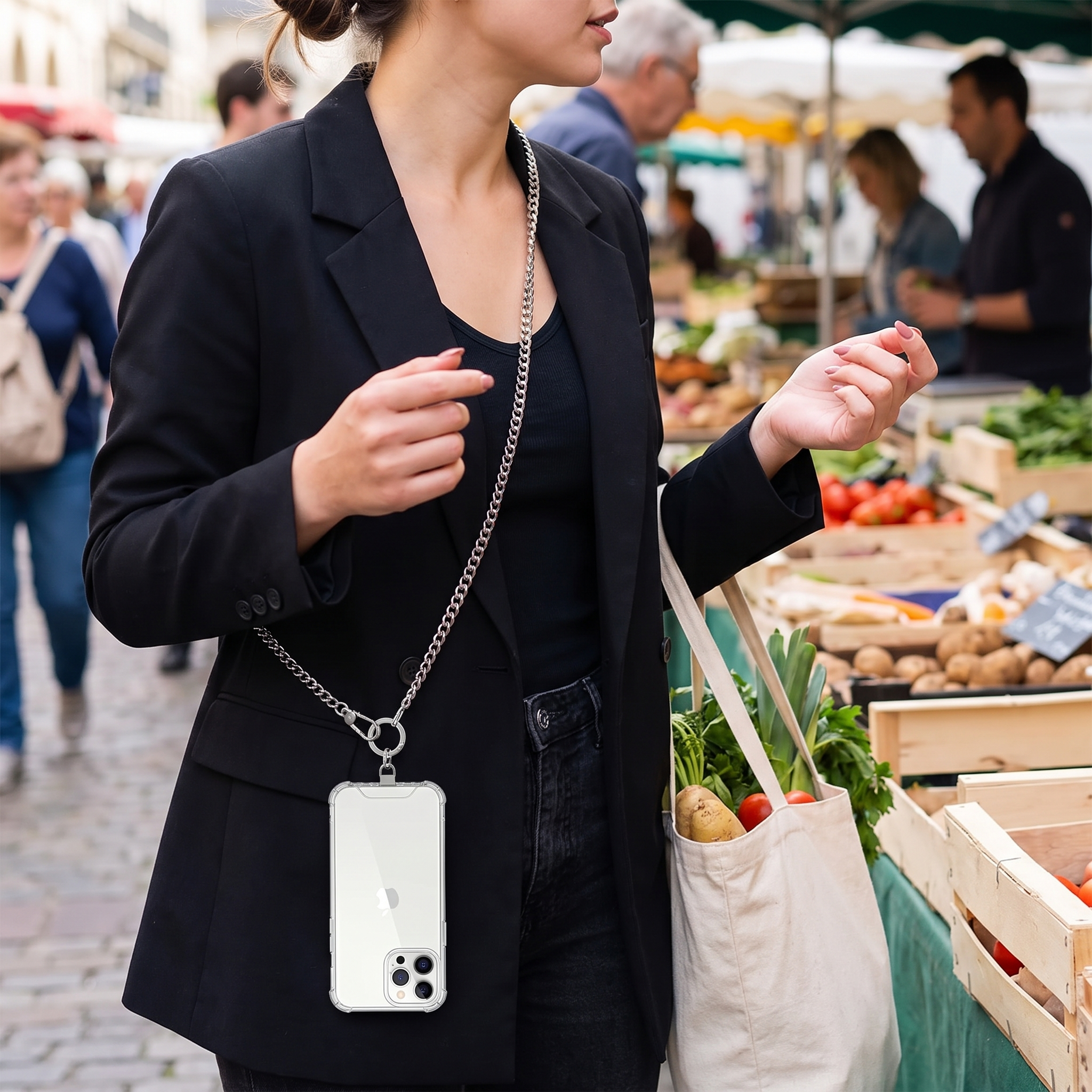 Person wearing phone hands-free on a crossbody lanyard strap at a market