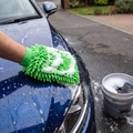 Person washing a car with a sudsy microfibre wash mitt, scratch-free